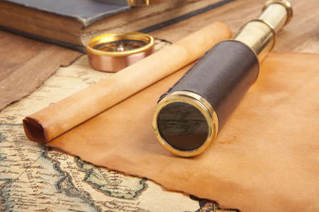 Vintage brass telescope on antique mapの写真素材