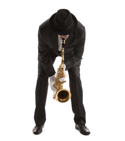 Saxophonist. Middle aged man playing on saxophone isolated on backgroundの写真素材
