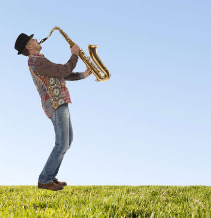 Saxophonist. Portrait of a man playing on saxophone の写真素材