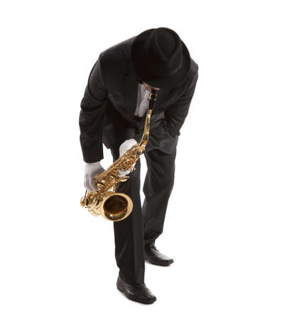 Saxophonist. Middle aged man playing on saxophone isolated on backgroundの写真素材
