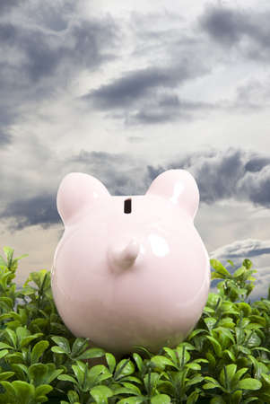 Piggy bank over blue sky の写真素材