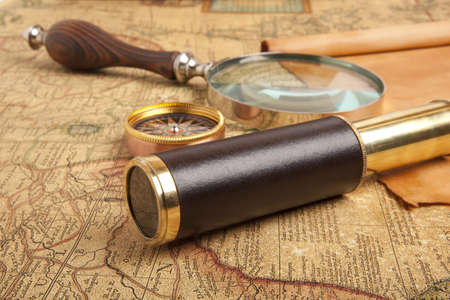 Vintage brass telescope on antique mapの写真素材