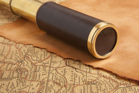 Vintage brass telescope on antique map