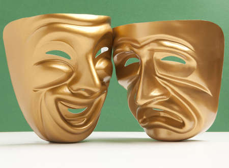 Comedy  and Tragedy theatrical mask on a green backgroundの写真素材