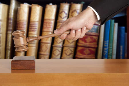 Gavel in hand against the background of the courtroomの写真素材