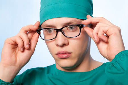 Portrait of a young surgeon on a blue backgroundの写真素材