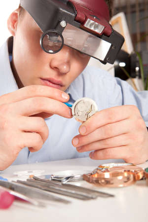 Watchmaker. Watch repair craftsman repairing watch 