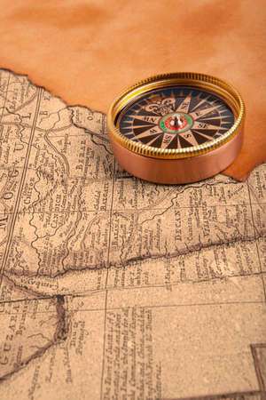 Old compass on vintage retro map 1687 