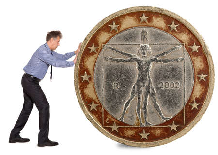 Businessman pushing a giant euro coin. Isolated on white の写真素材
