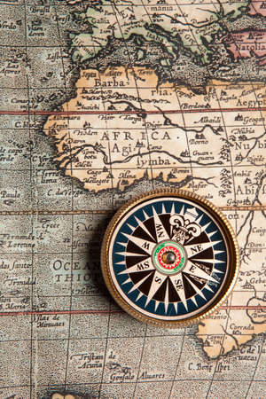 Old compass on vintage retro map 1687 の写真素材