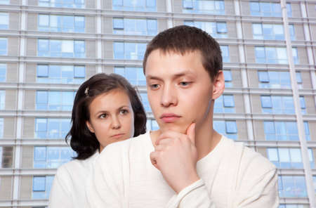Young couple quarreling against urban buildingsの写真素材