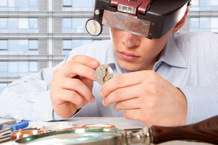Watchmaker. Watch repair craftsman repairing watch 