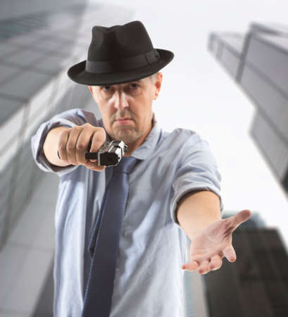 one man gangster is aiming a gun to youの写真素材