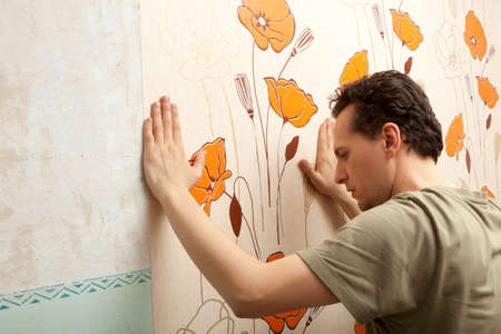 Decorator hanging wallpaper.  Repair and home conceptの写真素材