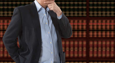 Lawyer businessman in front of bookcaseの写真素材