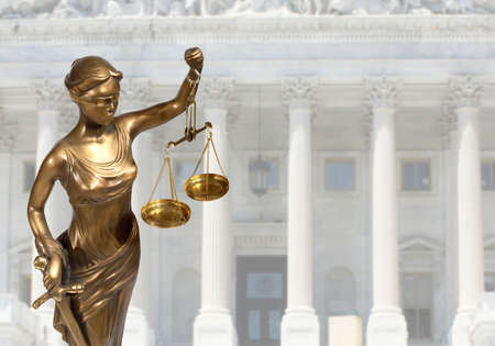 Justice statue is on against the courthouse Justice statue is on against the courthouse