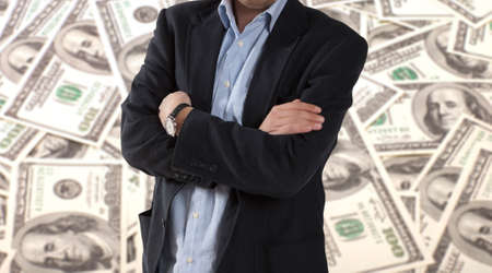 Businessman standing on a background of dollars