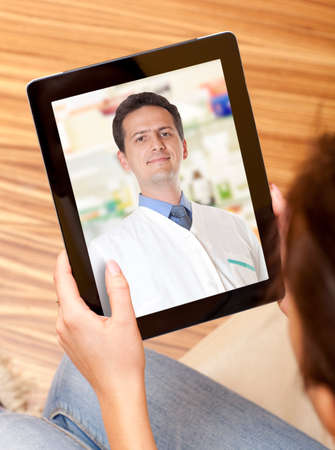 Woman having video chat with doctor on laptop at home