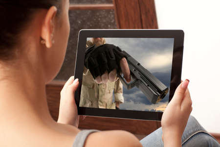 Cropped image of woman looking at action movie on tabletの写真素材