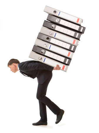 Frustrated businessman carries on the back pile of file foldersの写真素材
