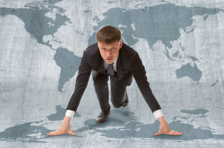 Young businessman standing in start pose ready to run.  WTO concept