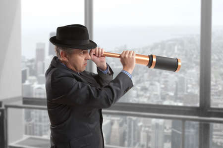 Business concept. Businessman looks through a telescopeの写真素材
