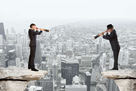 Businessman looks through a telescope. Concept for businessの写真素材