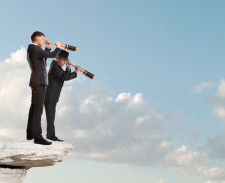 Businessman looks through a telescope. Concept for businessの写真素材