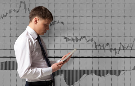 Stock trader looking at tablet computer in office