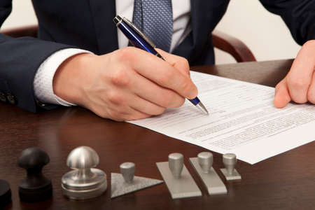 Lawyer, notary signs the documents from our officeの写真素材