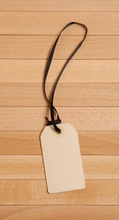 Vintage blank price tag on wooden background