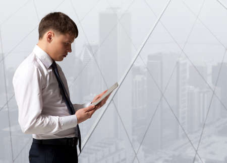 Businessman with tablet computer in officeの写真素材