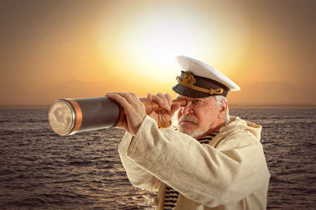 Captain looks through a telescopeの写真素材