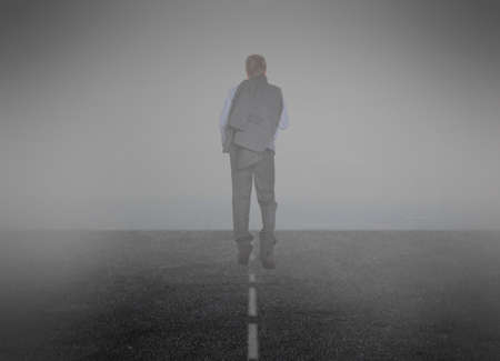 Smoke. Businessman goes into the mistの写真素材