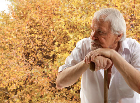 Autumn. Portrait of a senior man thinking about somethingの写真素材