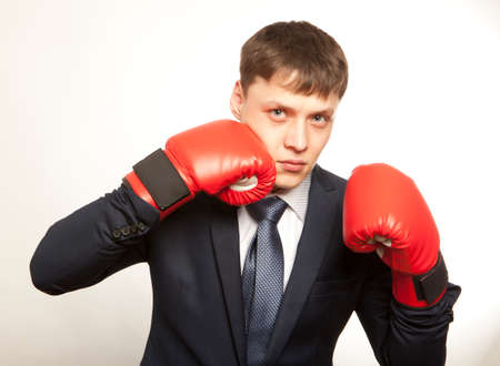Business concept. Businessman in red boxing glovesの写真素材