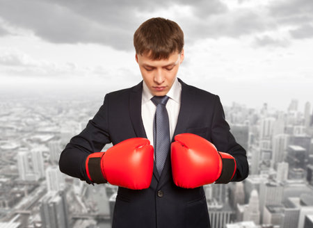 Business concept. Businessman in red boxing glovesの写真素材