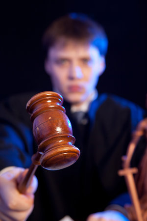 Judge. Male judge in a courtroom striking the gavel