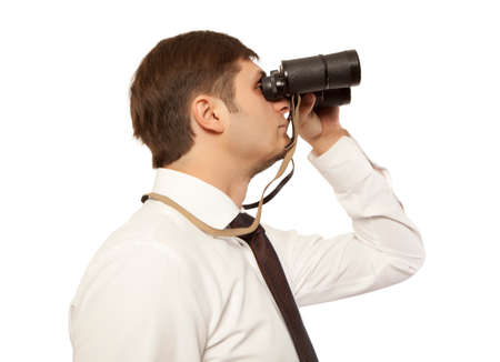 Businessman looking through binocularsの写真素材