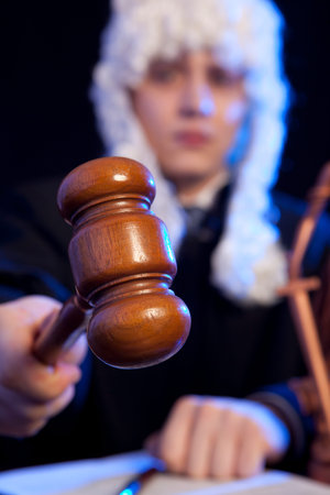 Judge. Male judge in a courtroom striking the gavel