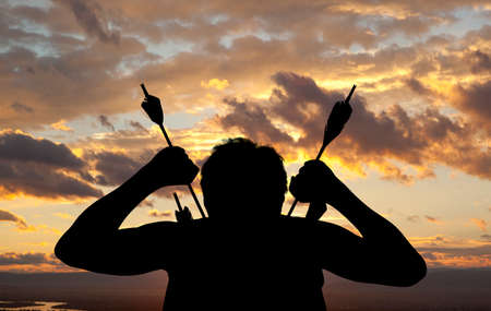 Silhouette of a witch-hunter of arrows. Fantasy conceptの写真素材