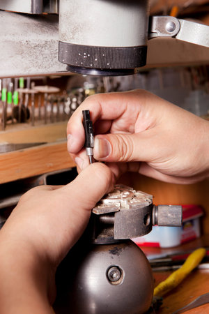 Jeweler crafting silver jewelry on his workbench