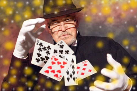 Magician show with playing cards. On color backgroundの写真素材