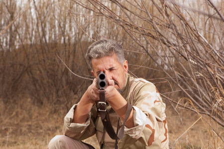 Hunter in camouflage clothes ready to hunt with hunting rifle