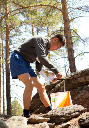 RUSSIA, ULAN-UDE - MAY 22, 2016: Russian Azimut - 2016. Orienteering competition is held annually in the Buryatia region. People at at control point at orienteering course.のeditorial素材