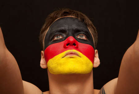 German fans at the stadium. Football, soccer fan. Black backgroundの写真素材