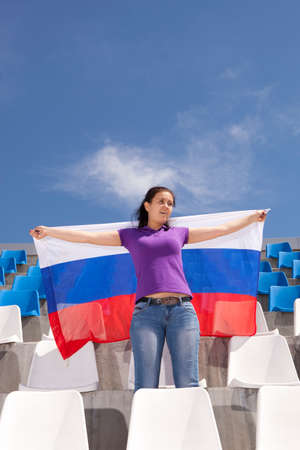 Girl sports fan waving flag Russiaの写真素材