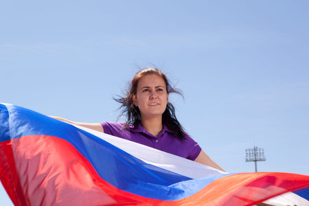 Girl sports fan waving flag Russiaの写真素材