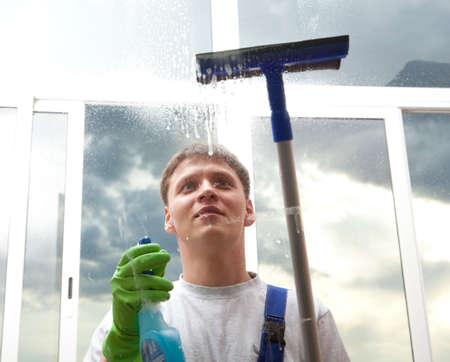Professional cleaning, man washes windowの写真素材