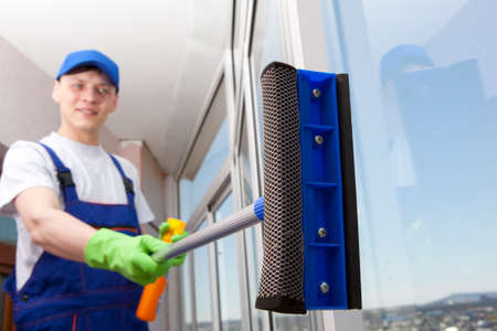 Professional cleaning, man washes windowの写真素材